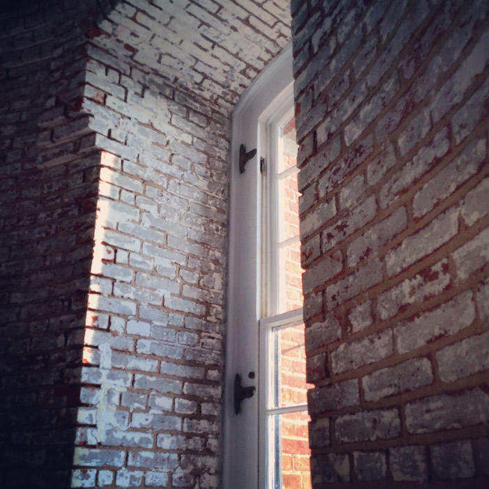 Window from within the lighthouse, showing the brick construction of the tower. Photo by Kimberly Toms.